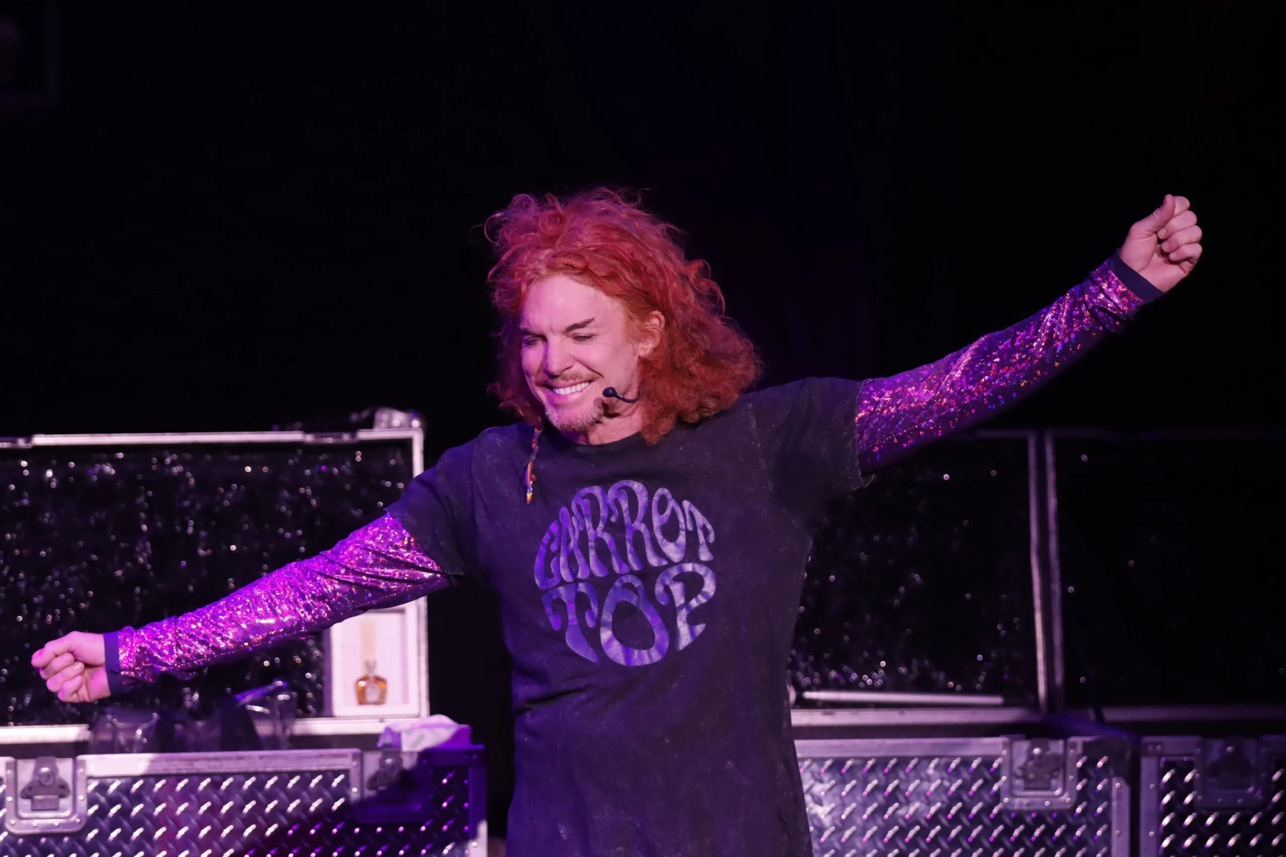 carrot top with red hair and microphone on the stages las vegas show