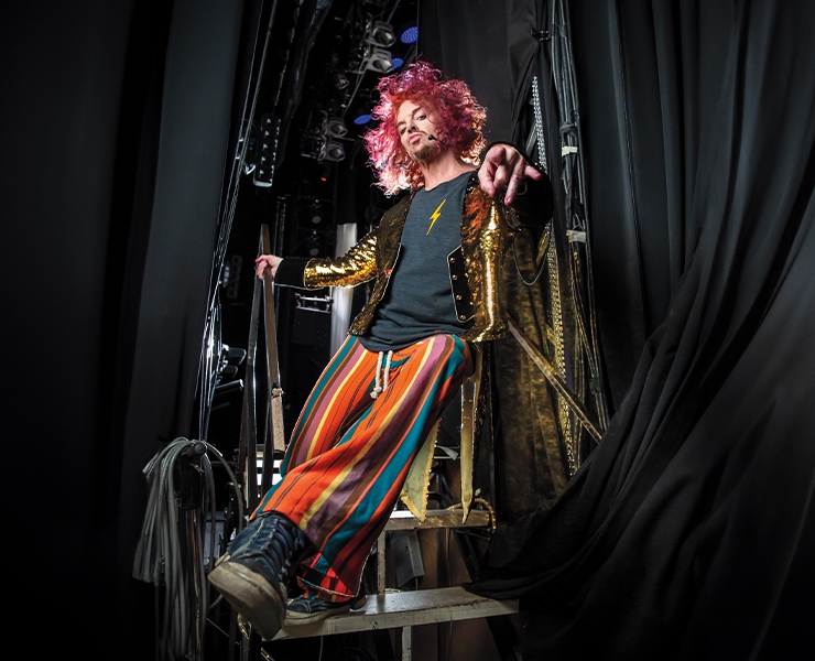 carrot top with pink hair sitting on a stage in the las vegas show